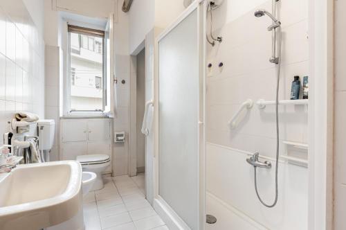 y baño blanco con lavabo y ducha. en Cagliari - Central & Roomy Apartment with Balcony!, en Cagliari