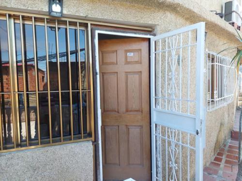 a door in a building with a gate at Alojamientos Nazareth in Catia La Mar