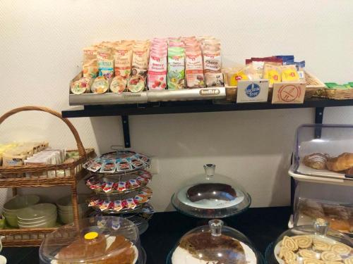 a shelf filled with lots of different types of food at Hotel Arcadia in Macerata