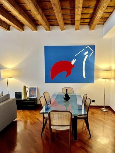 a dining room with a table and chairs at Il Portico. Charm apartment, Vicenza downtown. in Vicenza