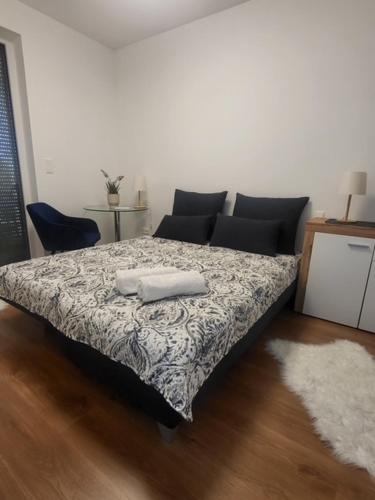 a bedroom with a bed with two towels on it at Mistral Residence 408 in Balatonföldvár