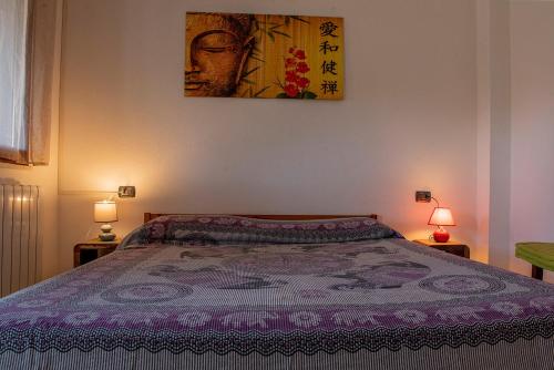 a bedroom with a bed with a purple blanket at Beth la Casa della Luna in Annunziata