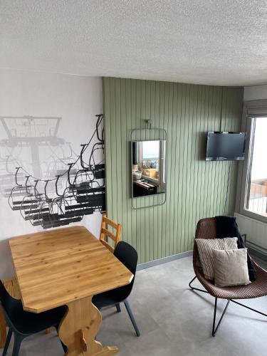 une salle à manger avec une table et des chaises en bois dans l'établissement Appartement vue montagne Val Thorens, à Val Thorens