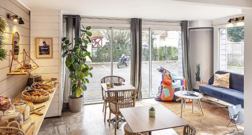 a living room with a couch and a table at Ostal Pau Universite - Sure Hotel Collection by Best Western in Pau