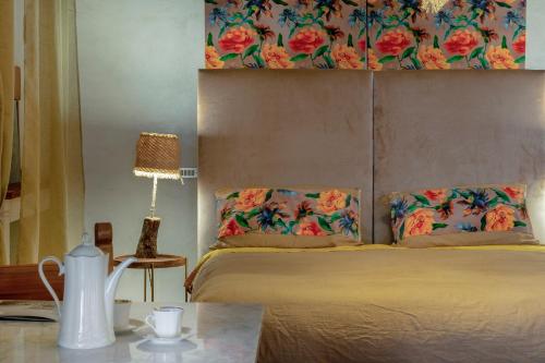 a bedroom with a bed and a table with a lamp at Villa Desiderio TUSCANY in Pistoia