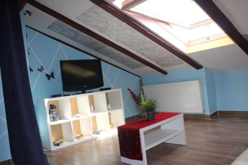 a living room with a skylight and a tv on a ceiling at Apartmani Matija in Opatija
