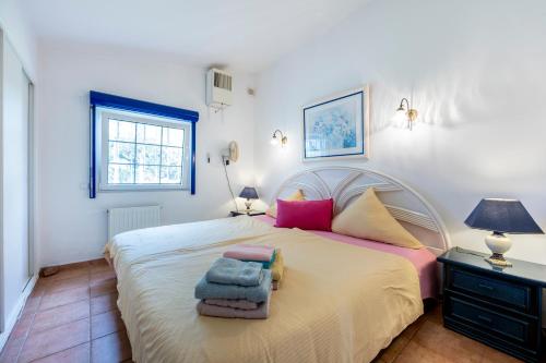 a bedroom with a large bed with towels on it at Seaside Retreat Casa Romana in Luz