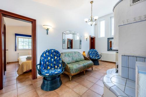 a living room with a chair and a mirror at Seaside Retreat Casa Romana in Luz