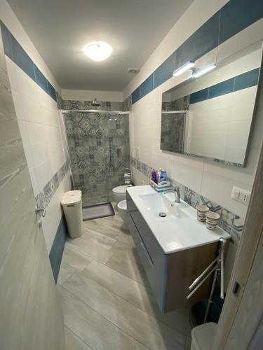 a bathroom with a sink and a toilet and a shower at Donna Cuncetta Casa Vacanza Monte di Procida in Monte di Procida