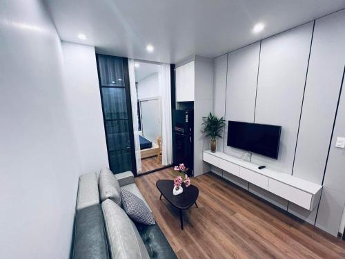 a living room with a couch and a tv at MinA Apartment - Vinhome Marina Hải Phòng in Hai Phong