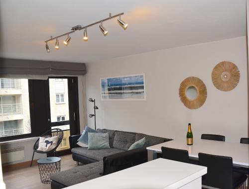 a living room with a couch and a table at SeeYou@Sea in Nieuwpoort