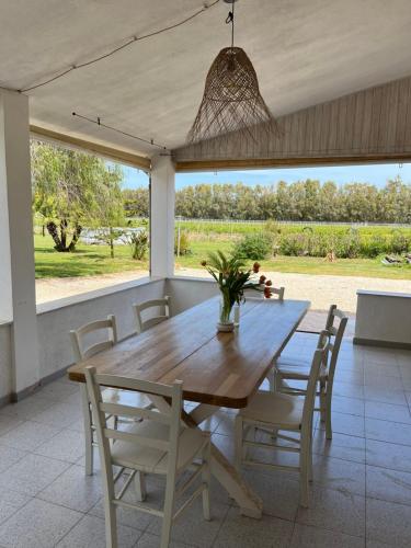 a dining room with a wooden table and chairs at Casa Marongiu in Santa Maria la Palma