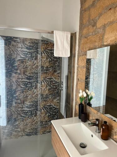 a bathroom with a sink and a shower at Casa Marongiu in Santa Maria la Palma