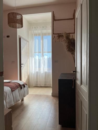a bedroom with a bed and a large window at Casa Marongiu in Santa Maria la Palma