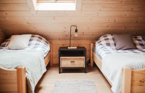 a room with two beds in a log cabin at Domek przy szlaku in Rabka-Zdroj