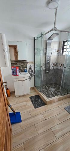 a bathroom with a shower with a glass enclosure at Luxury Villa in Port Louis