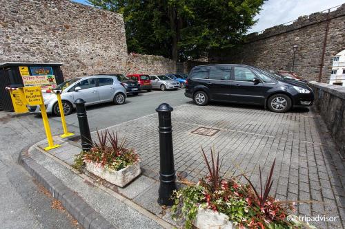 a group of cars parked in a parking lot at The Black Boy Inn in Caernarfon