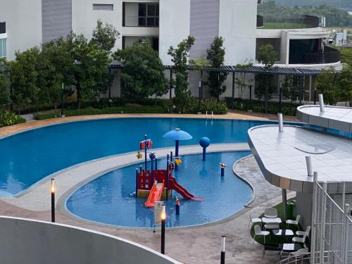 a swimming pool with a slide and an umbrella at LEGOLAND - 1-8 Pax Lego themed house with Superhero, Pirates & Forest at Puteri Harbour, Encorp Marina, Iskandar, Legoland in Johor Bahru