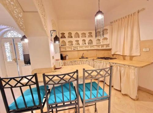 a kitchen with two chairs and a kitchen island at Cozy apartment in Downtown Gouna in Hurghada
