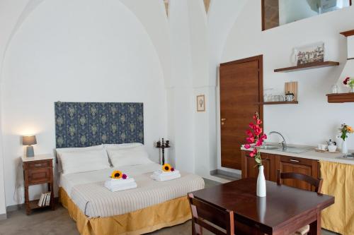 a bedroom with a bed with two pumpkins on it at La Corte Della Luce in Ugento