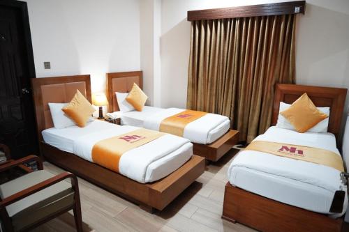Postel nebo postele na pokoji v ubytování Midtwon Hotel Islamabad