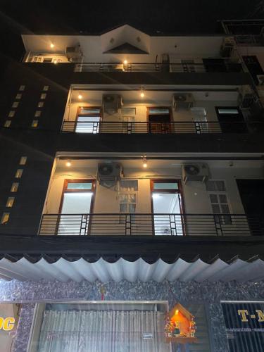 a building with two balconies with lights on it at Nhà Nghỉ Ánh Ngọc in Hue