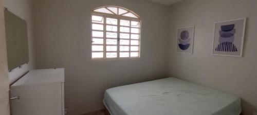 a small bedroom with a bed and a window at Riacho Fundo 1 - Riacho Mall in Brasília