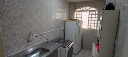 a small bathroom with a sink and a window at Riacho Fundo 1 - Riacho Mall in Brasília