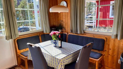 a table with chairs and a vase of flowers on it at Useriner Ferienhaus in Userin