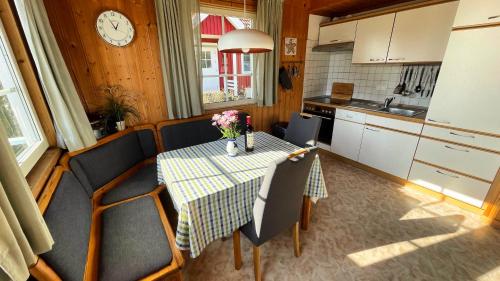 a kitchen with a table and chairs and a clock at Useriner Ferienhaus in Userin