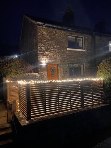 a building with christmas lights in front of it at Pretty little cottage in the peaks in Hadfield