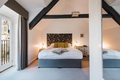 a bedroom with two beds and a large window at Mannings Hotel in Truro
