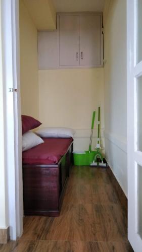 a small room with a bed in the corner at Roseville (Entire Apartment) in Shillong