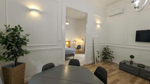 a living room with a table and chairs and a tv at 3 room apartment in the beautiful street in Budapest