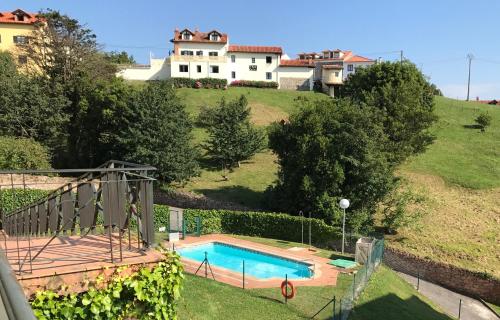 a house on a hill with a swimming pool at LA TERRAZA in Comillas
