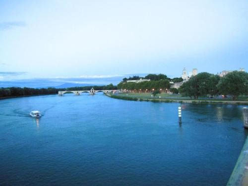 a river with a boat in the middle at Domaine Lafayette in Loriol-du-Comtat