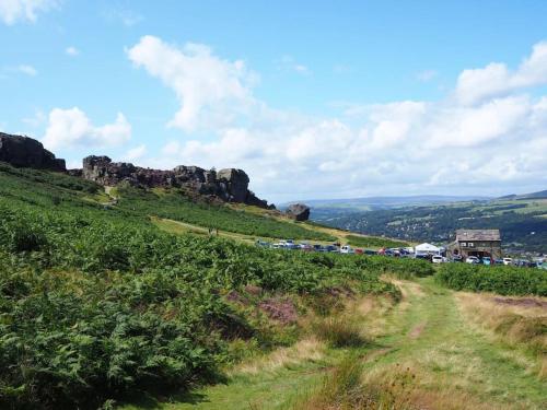 a grassy hill with cars parked on it at The Holt - Ilkley, central location, stylish apartment in Middleton