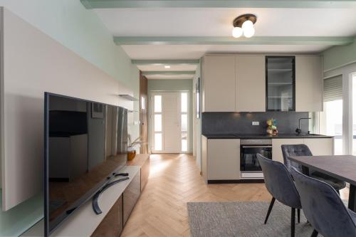 a kitchen and dining room with a table and chairs at Larum Apartmens in Vrsar