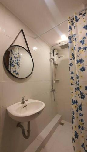 a bathroom with a sink and a mirror at MetroStay Oasis in Cebu City