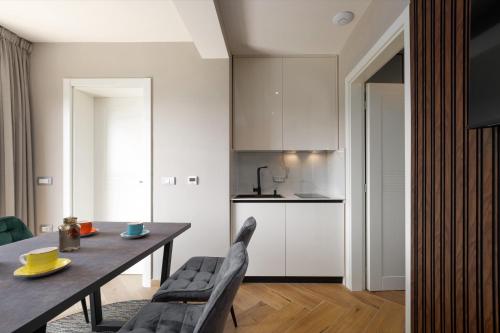 a kitchen and dining room with a table and chairs at Larum Apartmens in Vrsar