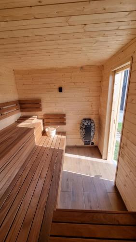 a sauna with wooden floors and a large window at Casa Guzinni 