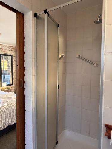 a shower with a glass door in a bathroom at Seaway Sunsets Relax & Enjoy the calmness with Lagoon & Sea views in Fisherhaven