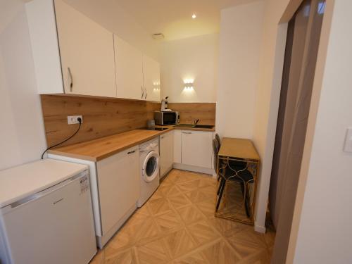 une petite cuisine avec un lave-linge et un lave-linge dans l'établissement Gîte de la Roche, à Saint-Alban-de-Roche