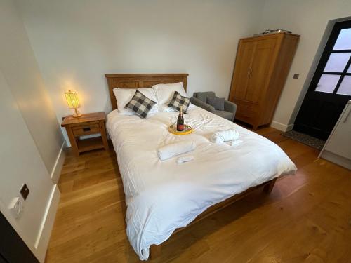 a bedroom with a large white bed with a tray on it at NEW King Bed Romantic Cabin - Must See Landscapes in Salisbury