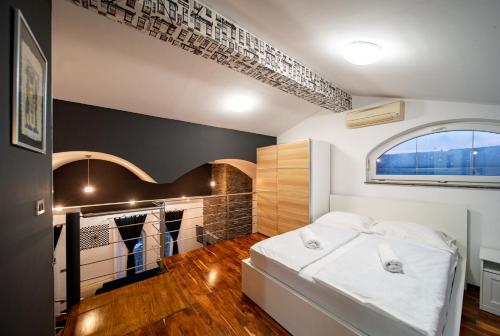 a bedroom with a bed and a walk in closet at Šanić Apartments 543/a in Lopar