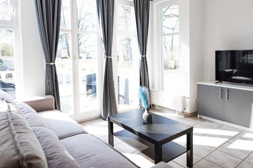 a living room with a couch and a coffee table at Villa Aida in Ahlbeck