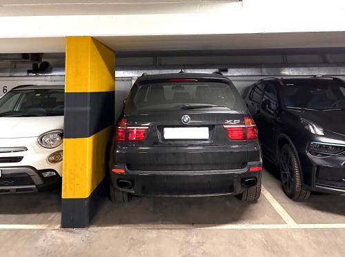 two cars are parked in a parking garage at Schöne Ferienwohnung im Zentrum von St. Moritz in St. Moritz