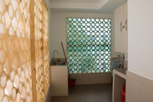 a kitchen with a large window in a room at TAUSI HOMES Sultan Palace Beach Resort in Kilifi