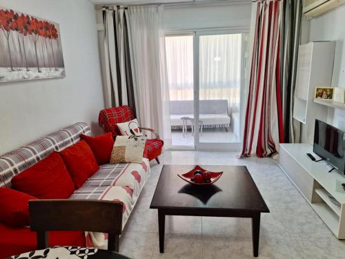 sala de estar con sofá rojo y mesa en Apartment Sunny Albir en Albir