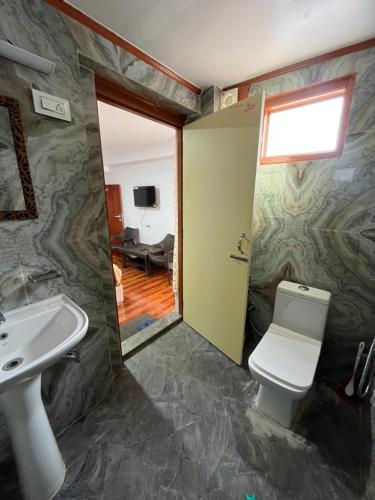 a bathroom with a sink and a toilet at Royal Vista - Guest House in Darjeeling